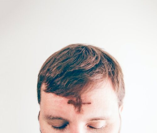 Man with an ash cross on his forehead